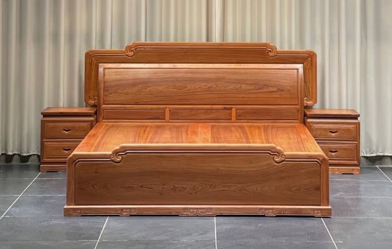 Detail of mortise-and-tenon joinery on a solid teak bed frame