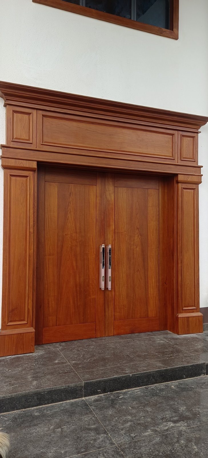 Teak entrance door grain detail showing golden figure