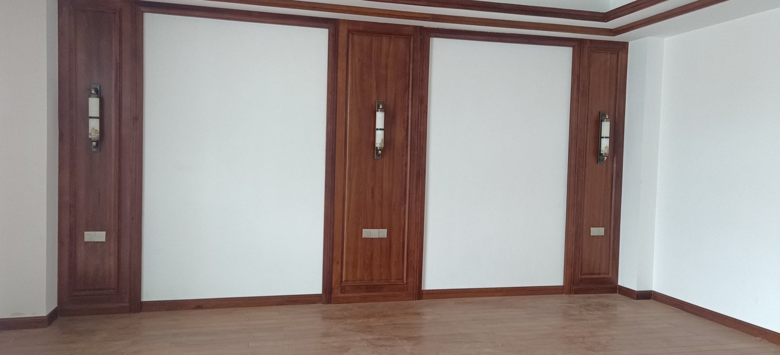 Warm teak feature wall glowing under soft lamplight