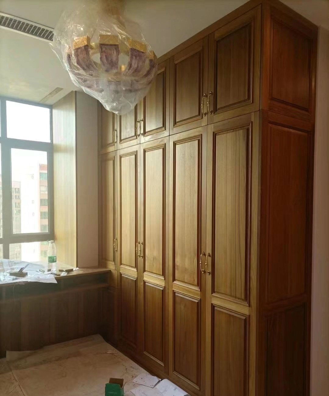 Custom teak wardrobe layout with hanging rails, drawers and shelves
